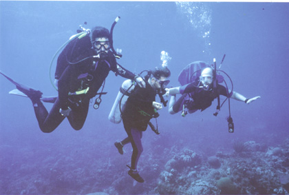 2 people holding on to gene diving underwater