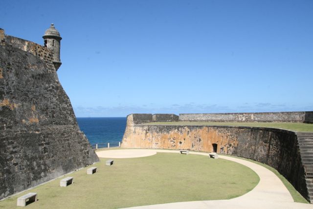 A stone castle next to a body of water