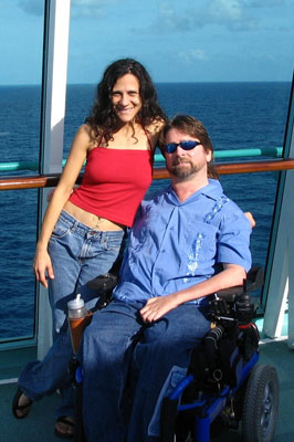 Gene and Cheryl smile on  the cruise deck during a sunny bright day