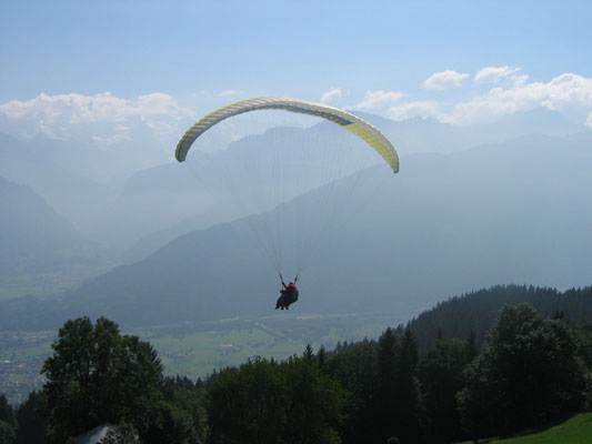 Gene and an instructor paragliding above Switzerland. 