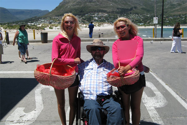 two women holding baskets pose for the camera with Gene