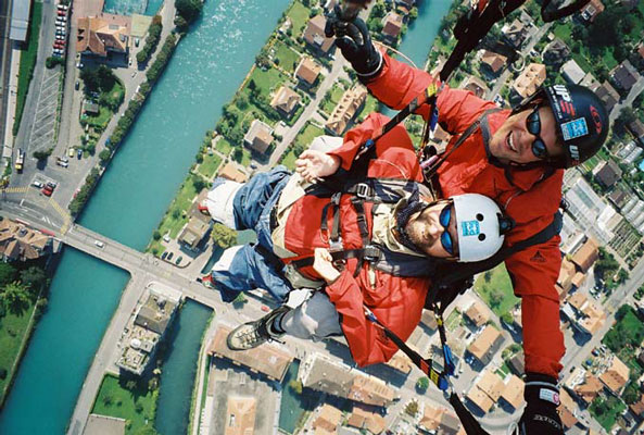 Gene above Switzerland with an instructor while paragliding