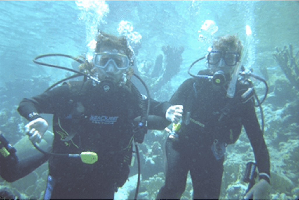 Gene and a friend seen underwater scuba diving