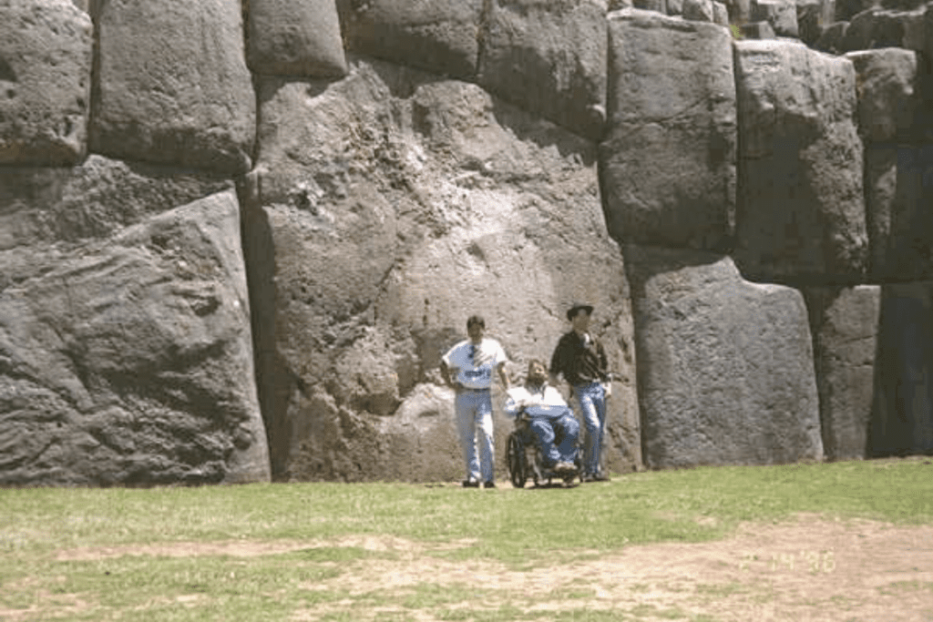 Gene poses in front of ancient ruins in Machu Pichu with his guides, Alex and Jaime