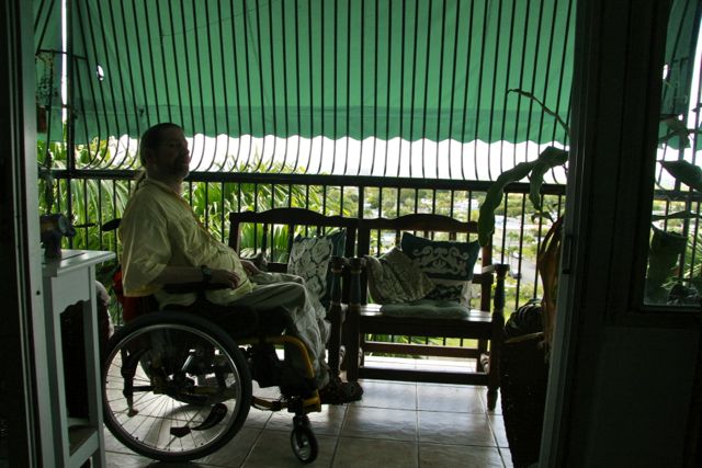 Gene sitting in his wheel chair on the porch of a home in Puerto Rico