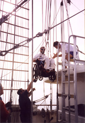 Gene being lowered by two people using a block and tackle system