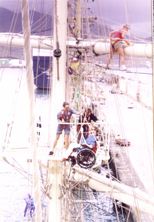 Gene being lowered on by two people using a block and tackle system