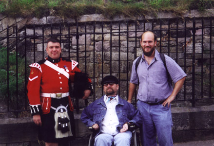 A bagpiper player and Gene and a friend pose for the camera
