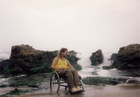 Gene relaxing on a beach while in his wheel chair.