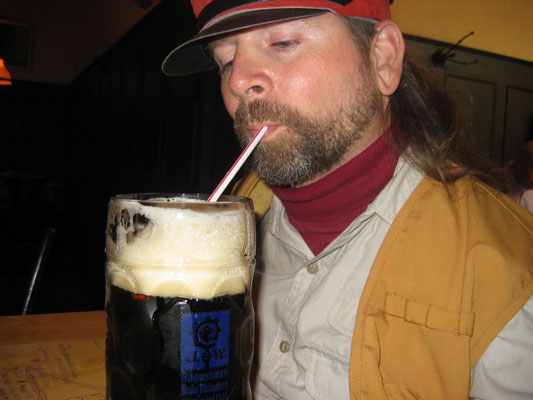 Gene sips a dark beer