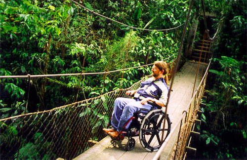 Gene on a dangling wooden bridge in the forest