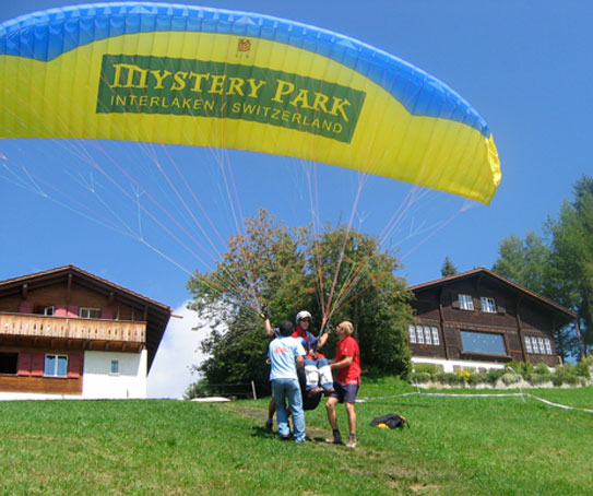 An open paraglider on the ground