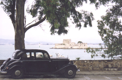 A car parked in front of a body of water