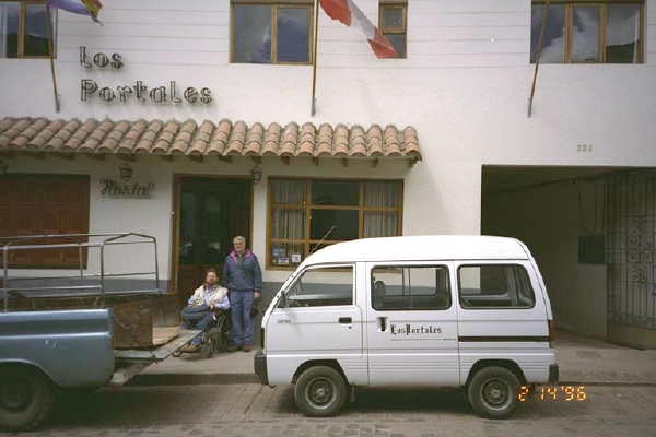 A truck is parked in front of a hotel in Peru with Gene and Don standing outside