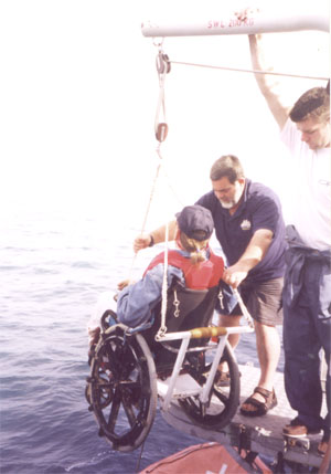 Gene being lowered into a dinghy