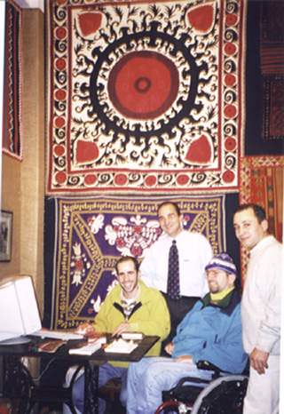 Gene and Turkish friends pose in front of a beautiful authentic Turkish carpet