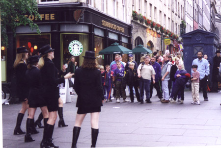 A group of people walking on a city street