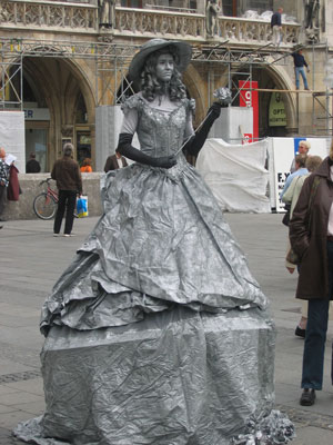 A woman performing as a statue as part of street art 