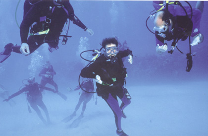 a group of people posing for a picture underwater