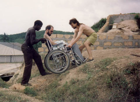 Gene's friend bill being pulled up a hill in his wheel chair