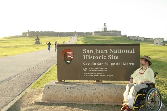 Gene poses in front of a National Park sign in Peurto Rico