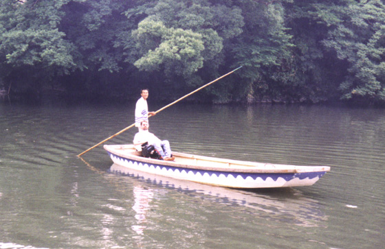 Gene with a man rowing a boat on water