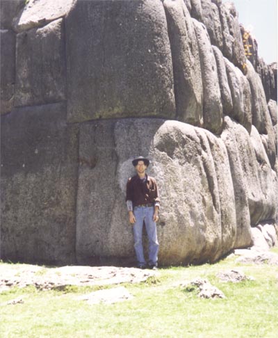 Gene's tour guide Jeff poses in front of large stone blocks