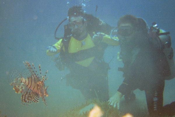 Gene scuba diving with a Lion Fish nearby.