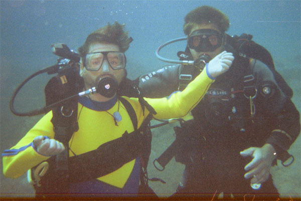 Gene Rodgers scuba diving with an instructor.