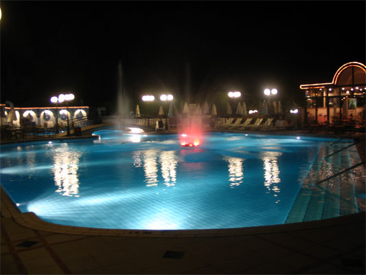 Oases hotel pool lit up at night in Egypt, Africa.