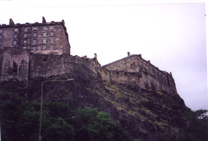 A large brick building with a mountain in the background