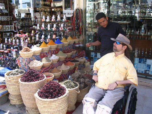 A group of people sitting at a produce market