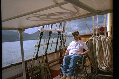 Gene sitting on a ship deck