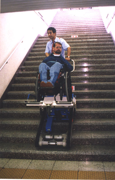 Gene going down the stairs in a stair wheelchair