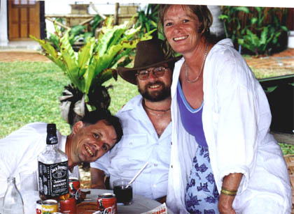 Gene, Steve and Wendy pose for the camera at a restaurant table in Thailand.