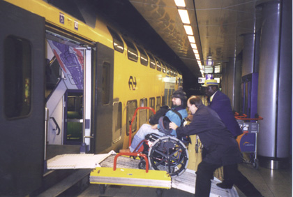 Gene using a ramp to get on a subway train car