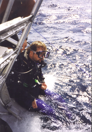 A man riding on the back of a boat