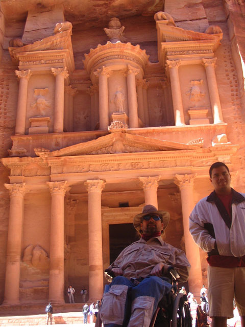 Gene and a guide in front of Petra carved buildings