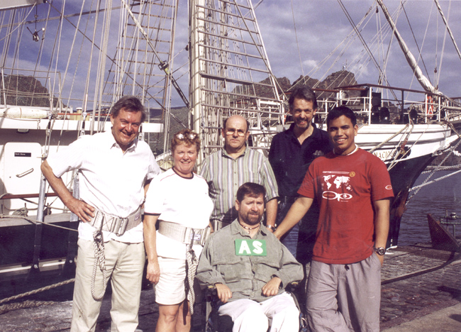 Gene posing with 5 other people on the ship