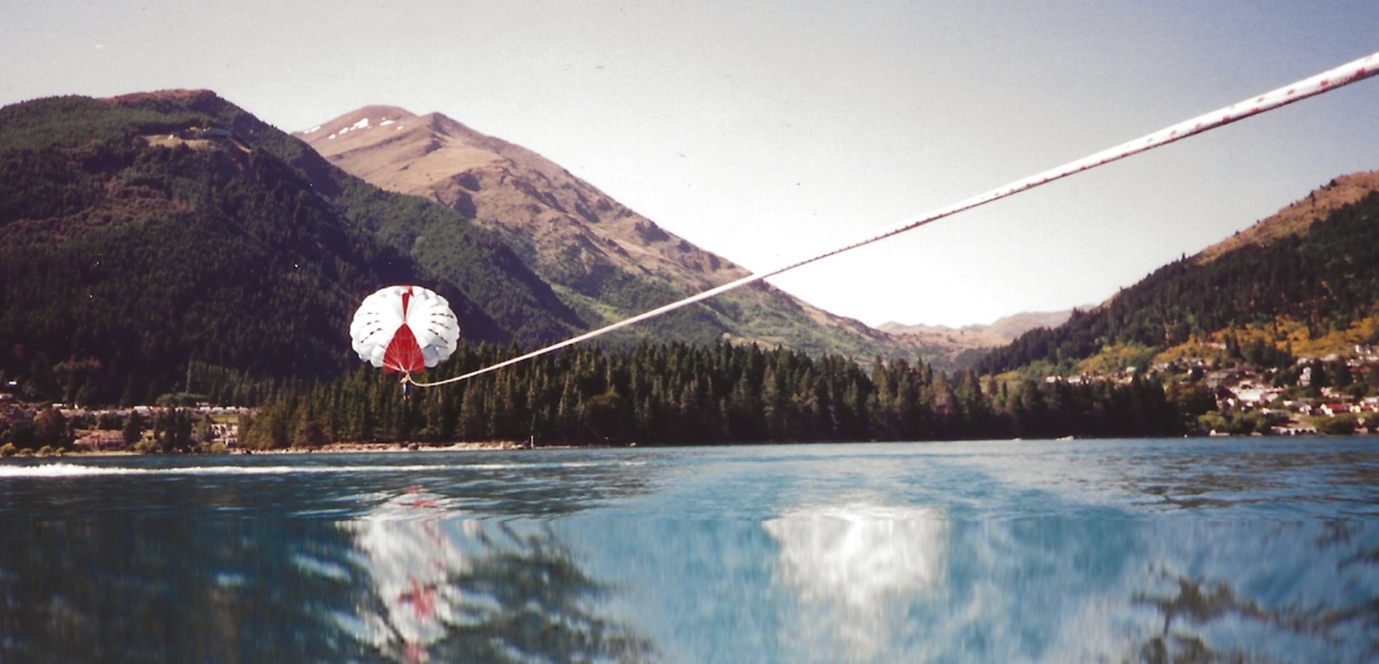 A body of water with a mountain in the background