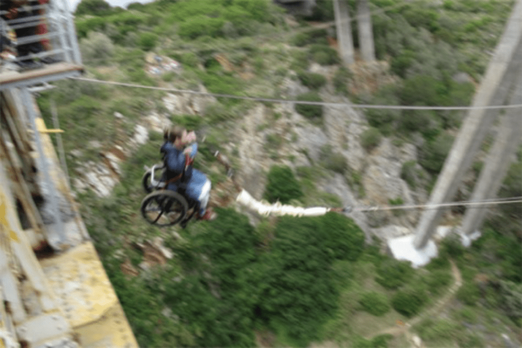 Gene in mid-air while Bridge Swinging in his wheel chair