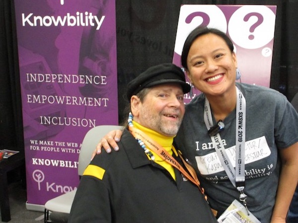 Gene smiling at the camera with a person at a Knowbility event