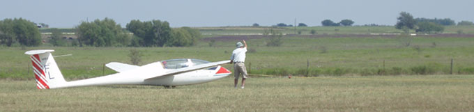 A small plane sitting on top of a grass covered field