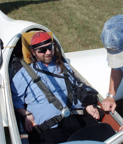 Gene sitting in the cockpit of an airplane