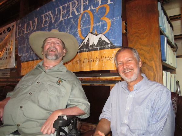 Gene sits next to Dennis, Executive Director of Coalition of Texans with Disabilities