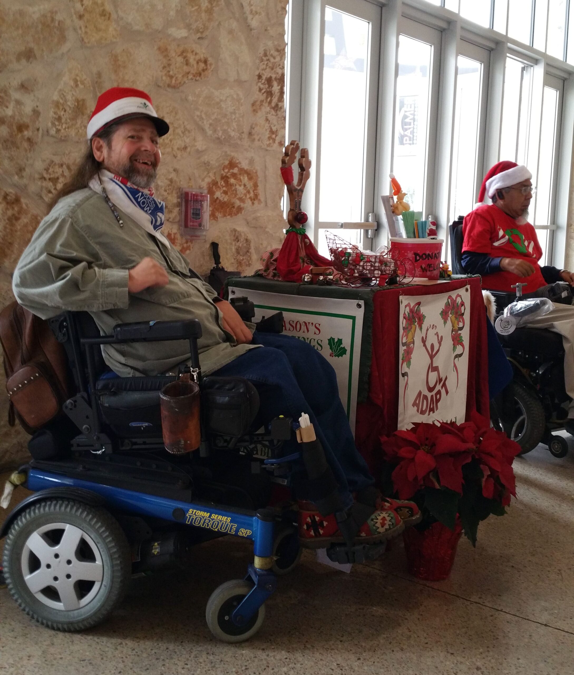 Gene manning a table to collect donations for ADAPT, a disability rights organization.