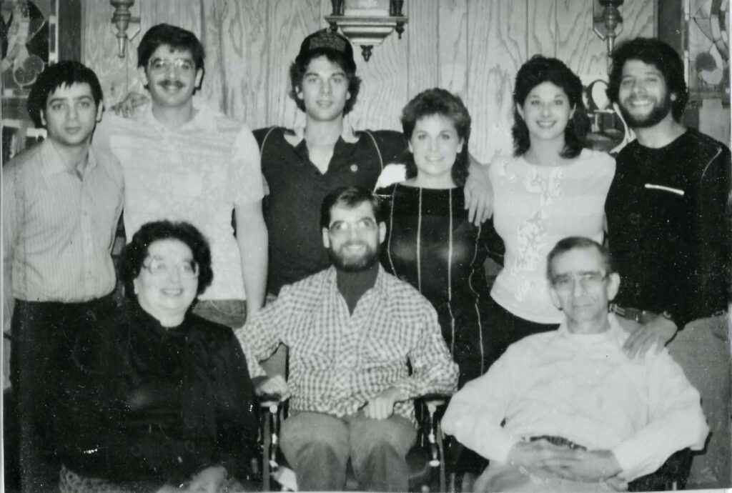 Gene sits between his parents Mary and Bob Back row includes brothers Robert, Bill, Ron, sisters Mindy and Pam, brother Mike