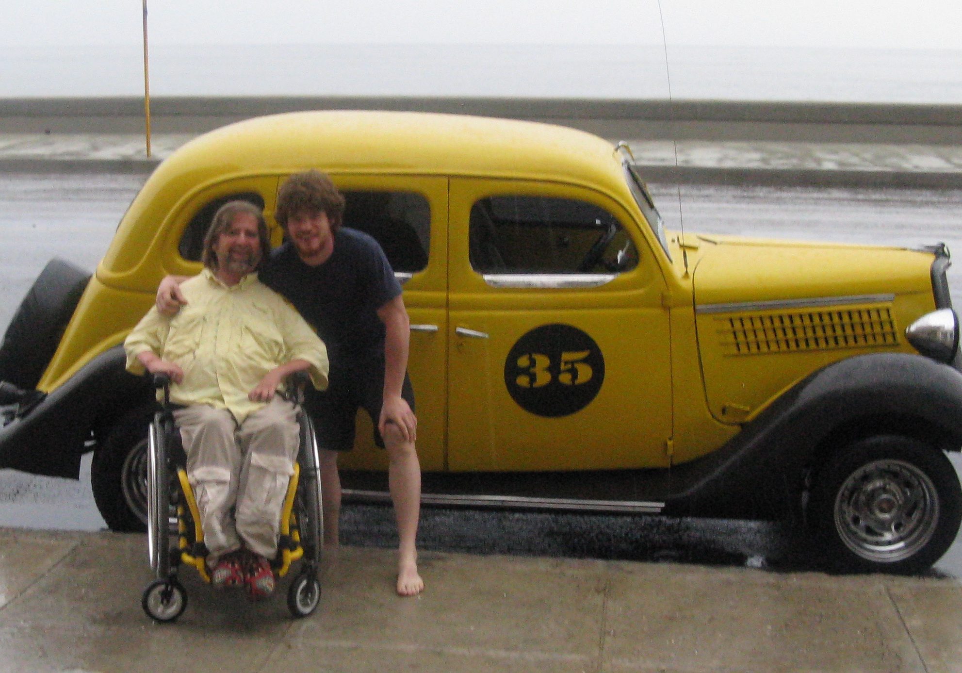 gene and Pedro in front of a yellow car