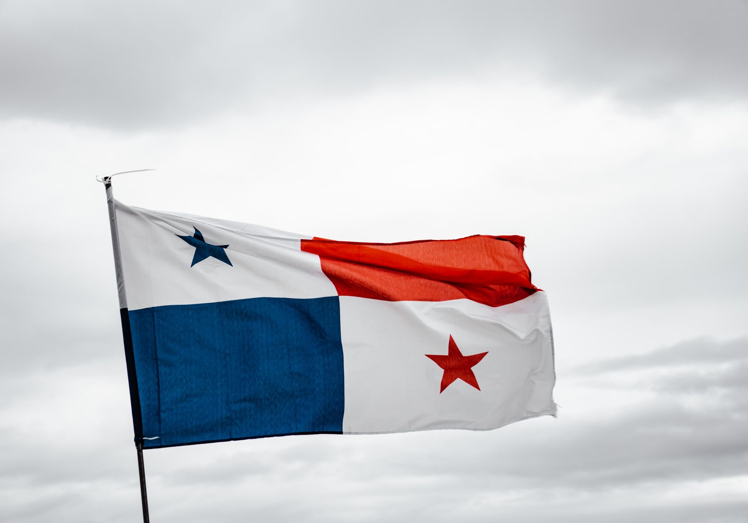 A Panama flag flying on a cloudy day